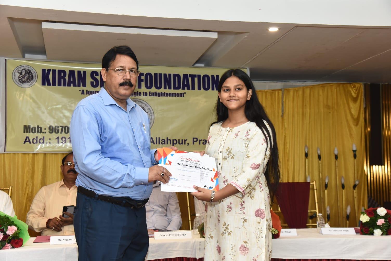 Shiksha Jaiswal receiving the Certificate of Internship before the high table with Col. Prasoon Singh & dignitaries